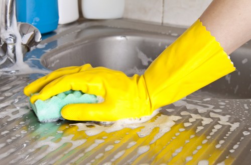 Cleaner in Greenwich performing deep cleaning in a kitchen