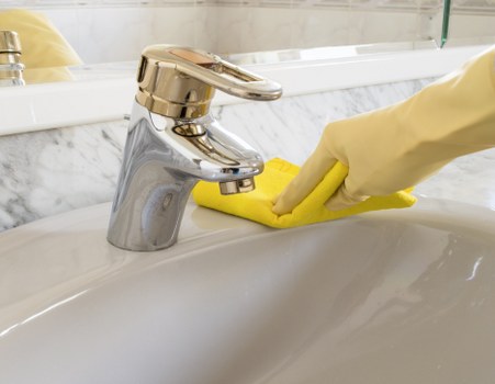 Professional cleaner using protective equipment during a task